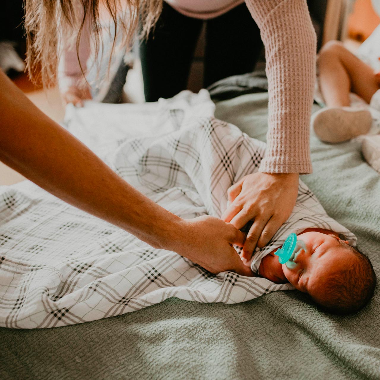 Swaddle baby with discount hands by face